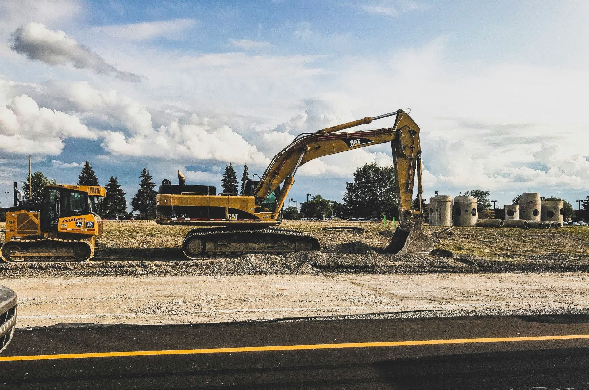 yellow Caterpillar excavator digging up dirt