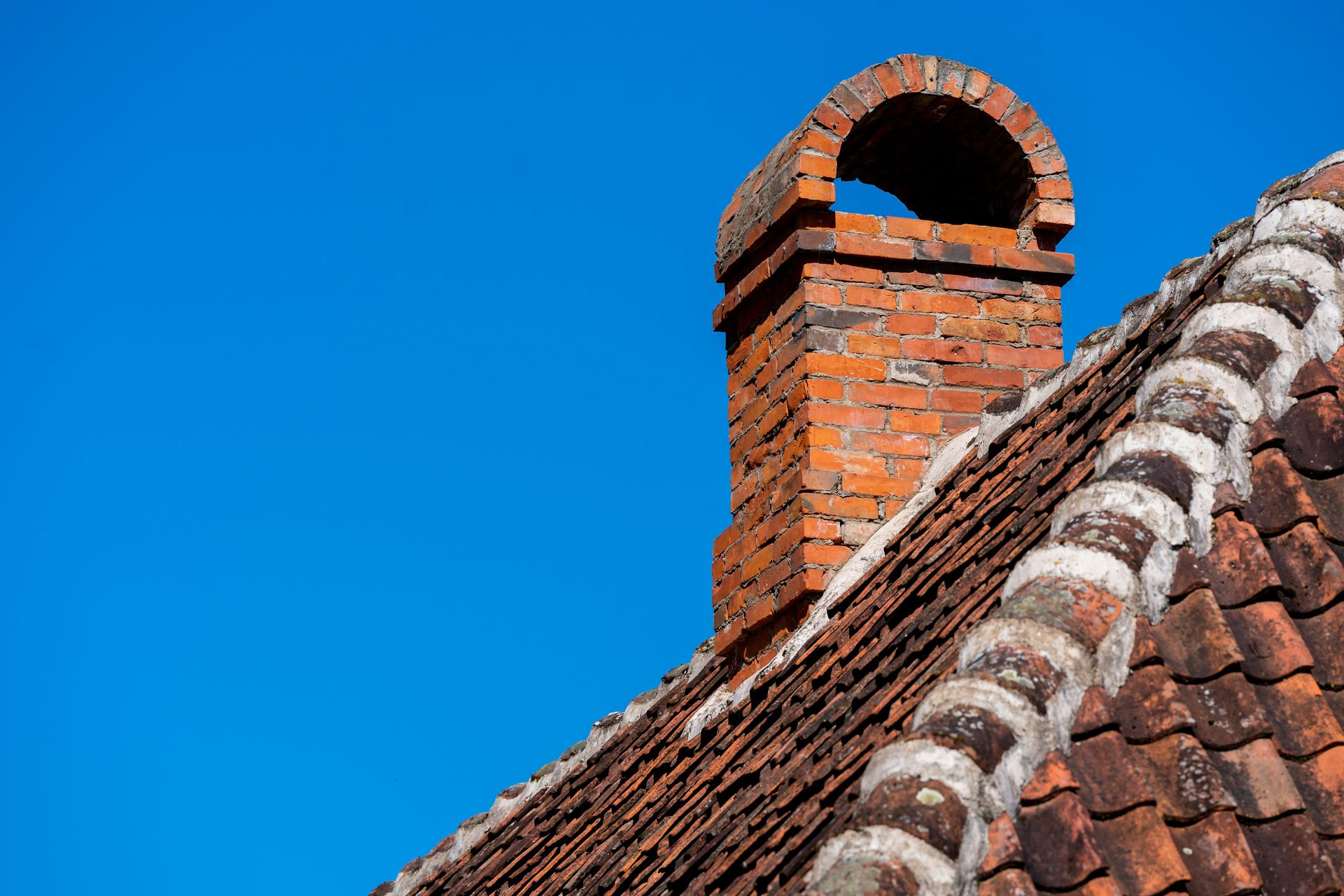 a brick chimney with a blue sky in the background