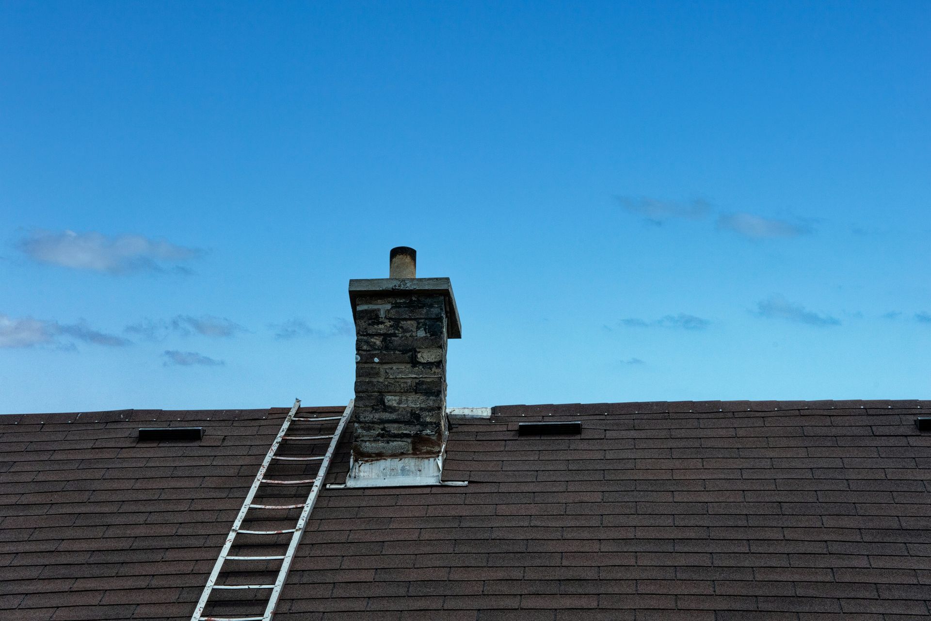 a ladder is on the roof of a house